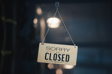 sorry we are closed sign hanging outside a restaurant, store, office or other. Closed sign in a...