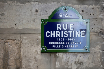 Close up view of a street sign of Rue Christine in Paris.