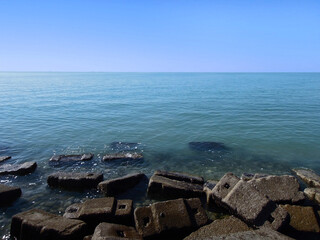 Used concrete blocks dumped in a pile near shoreline of sea port in Bushehr, Iran. Stones are...