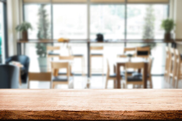 Empty wooden table space platform and blurred restaurant or coffee shop background for product display montage.