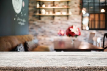 Empty wooden table space platform and blurred restaurant or coffee shop background for product display montage.