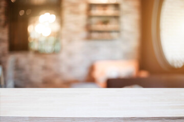 Empty wooden desk space platform and blurred resturant or coffee shop background for product display montage.