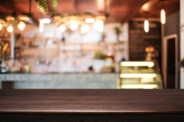 Empty wooden table space platform and blurred resturant or coffee shop background for product display montage.