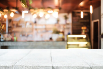 Empty wooden table space platform and blurred resturant or coffee shop background for product display montage.