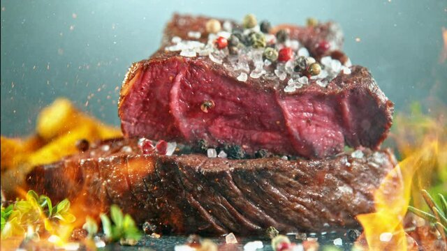 Close-up of falling tasty beef steak, super slow motion, filmed on high speed cinematic camera at 1000 fps.