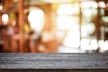 Empty wooden table space platform and blurred resturant or coffee shop background for product display montage.