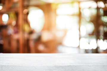 Empty wooden table space platform and blurred resturant or coffee shop background for product display montage.