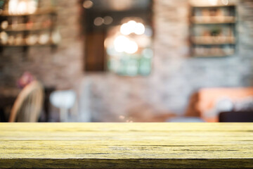 Empty wooden table space platform and blurred resturant or coffee shop background for product display montage.