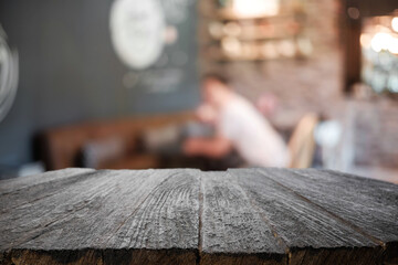 Empty wooden table space platform and blurred restaurant or coffee shop background for product display montage.