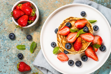 Pancakes with fresh berries and honey.
