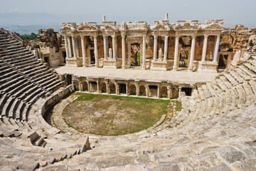 Fototapeta na wymiar Monumental amphitheater at archaelogical site of the ancient Greek city of Hierapolis, near Pamukkale, Denizli, Turkey