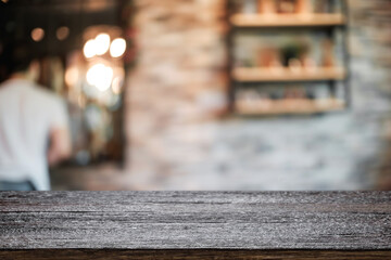 Empty wooden table space platform and blurred resturant or coffee shop background for product display montage.