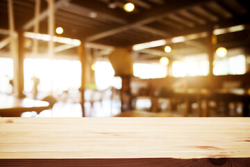 Empty wooden table space platform and blurred resturant or coffee shop background for product display montage.