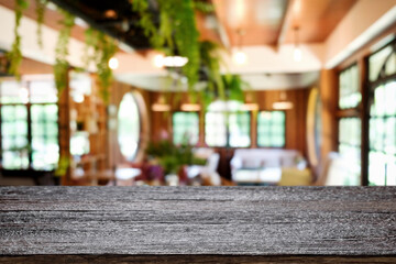 Empty wooden table space platform and blurred resturant or coffee shop background for product display montage.