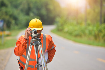 Surveyor engineer worker making measuring with theodolite on road works.survey engineer in construction site.