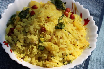 Poha or Kanda Poha popular Maharashtrian breakfast recipe made from red or white flattened rice, potatoes, onions, herbs and spices. 