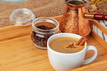 Obraz na płótnie Canvas Cup of americano coffee with cinnamon close up