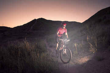 man riding a mountain bike at dusk © javi