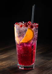 cranberry lemonade with ice, cocktail in a tall glass with a straw
