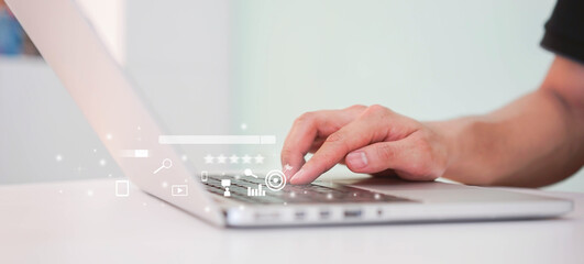 close up man hand type on keyboard laptop to use search engine optimization (SEO) tools for finding customer or promote and advertise about content online for marketing technology and business concept