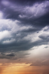 Obraz premium Natural sky composition. Dark ominous colorful storm rain clouds. Dramatic sky. Overcast stormy cloudscape. Thunderstorm. Element of apocalypse design. Toned.