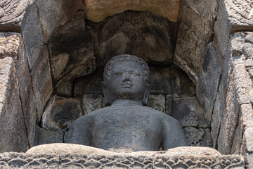 Fototapeta na wymiar Niches and holes in the lower balustrades of the Borobudur temple in Central Java, Indonesia, its function is to house the ancient statues of the Buddha.