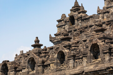 Fototapeta premium View of the rows of balustrades and niches, decorated with their respective stupas and reliefs, in the eastern part of the Borobudur temple, Central Java, Indonesia.