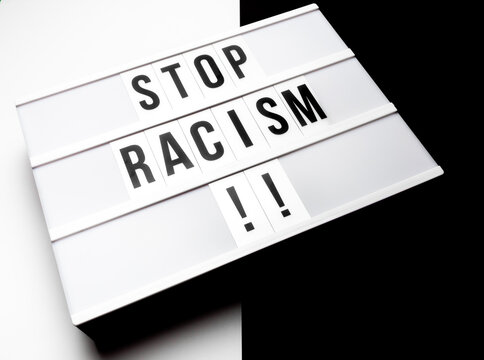 Light box with the text "stop racism" against black and white background