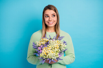 Close-up portrait of her she nice-looking attractive lovely cute sweet lovable dreamy cheerful cheery girl holding in hands flowers isolated on gray bright vivid shine vibrant blue color background