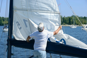 Yachtsman setting sail of a yacht before race
