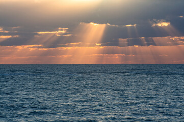 Seascape. The sun's rays break through the clouds and descend to the Black Sea.