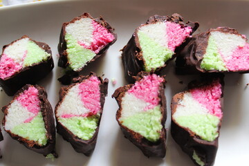 Colorful sweet on a chocolate plate