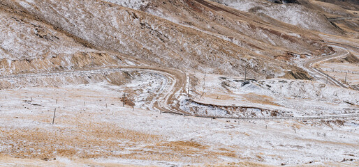 Obraz na płótnie Canvas the gravel road on the snow mountain