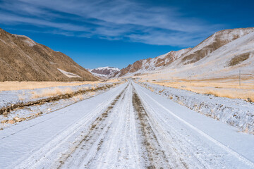 the gravel road on the snow mountain