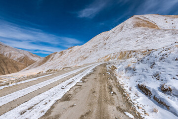 the gravel road on the snow mountain