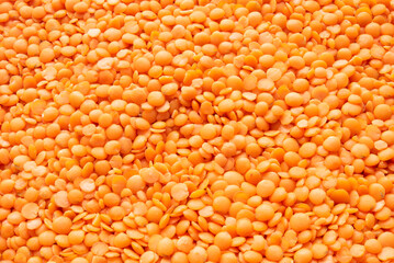 Red lentils background. Focus all over the frame.