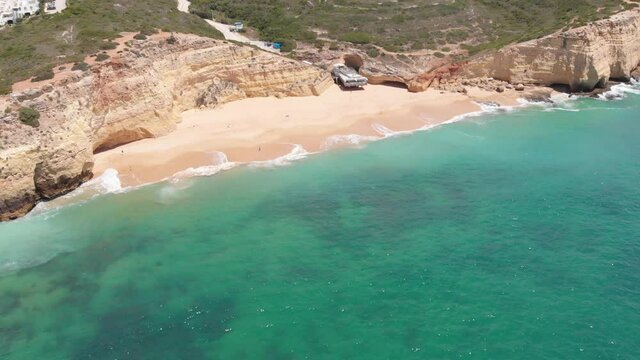 Aerial top down view small picturesque beach translucent waters, Algarve