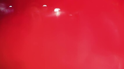 Young female students sitting talking and laughing at a bar, blurry video with flares and light leaks symbolizing blurred vision after getting drunk, dizziness