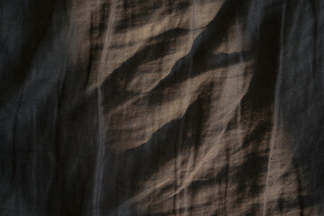 dark gray linen textile texture with sunlight