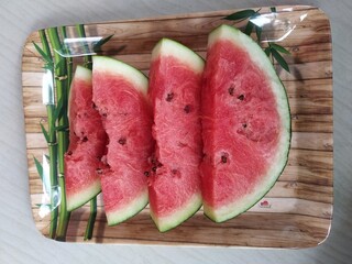 Closeup view of slices of  fresh watermelon (Citrullus lanatus) on a plate