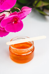 Shugaring paste in a jar with a spatula. Sugar paste for hair removal