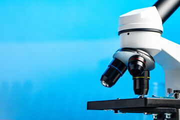 Lab microscope close up against blue background