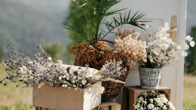 Wedding decorations, beautiful flowers near wedding arch in the mountains