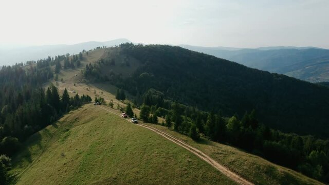 Beautiful mountain landscape with off-road driving, several jeeps go off-road