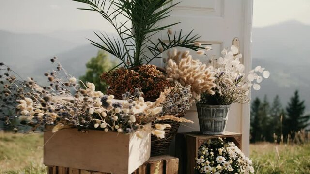 Wedding decorations, beautiful flowers near wedding arch in the mountains