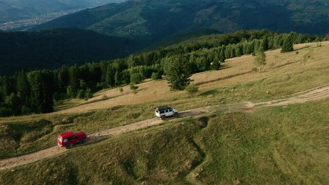 Beautiful mountain landscape with off-road driving, several jeeps go off-road