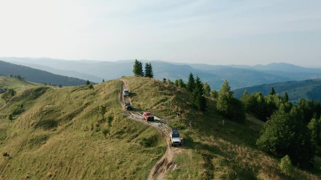 Beautiful mountain landscape with off-road driving, several jeeps go off-road