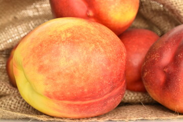 Ripe juicy organic nectarine, macro, on a white background.