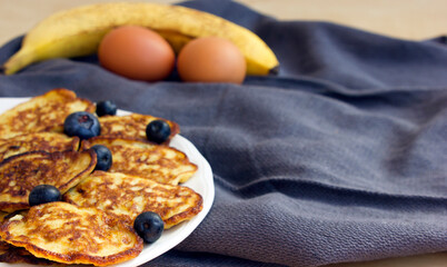 banana oat pancakes with blueberries. selective focus. Home made. Banana and eggs. Healthy breakfast.