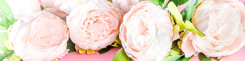 Floral peonies arrangement . Artificial tender white pinkish peony flower with leaves, flat composition on a light background. top view place for text